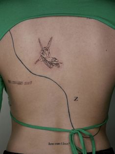 the back of a woman's stomach with a tattoo on her left side and an arrow