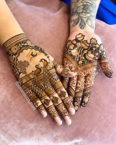 two hands with henna tattoos on them