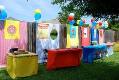 an outdoor party with balloons and decorations