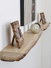 a wooden shelf with two pictures on it