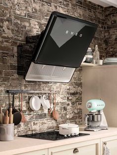 a kitchen area with a stove, microwave and various cooking utensils