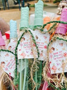 there are some straw wrapped candles in the basket with tags on them that say thank you for coming home