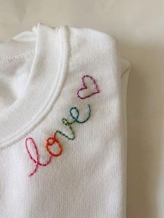 a t - shirt with the word love embroidered on it