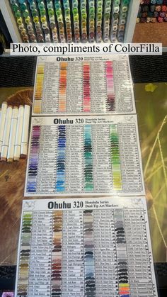 two rows of different colored pencils sitting on top of each other in front of a display case