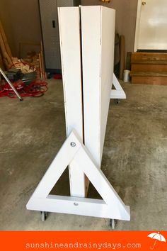 a pair of white storage cabinets sitting on top of each other in a garage next to tools