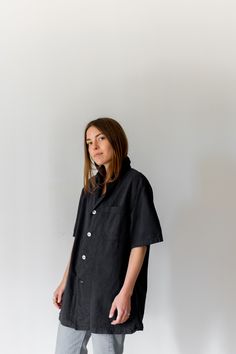 "Black short sleeve over shirt with one front chest pocket and four white buttons. Thicker over shirt material. Maker: Military | Made in USA in the 60s. Garment Dyed in Los Angeles in 2019. Material: 100% Cotton 6 oz. Condition: Excellent. may have tiny pin holes. -X SMALL- Shoulders: 17\" | Chest: 18\" | Length: 28\" | Sleeve: 10\" -SMALL- Shoulders: 17\" | Chest: 20\" | Length: 28\" | Sleeve: 10.5\" -MEDIUM- Shoulders: 18\" | Chest: 21-22\" | Length: 30\" | Sleeve: 11\" -LARGE- Shoulders: 20\ Dark Green Shirt, Small Shoulders, Blue Button Up Shirt, Army Pants, Work Coat, Army Jacket, Half Zip Sweaters, Blue Denim Shorts, Work Shirt