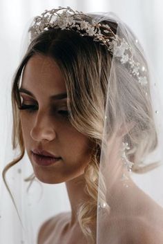 a woman wearing a veil with flowers on it