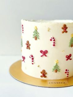 a decorated christmas cake sitting on top of a wooden plate