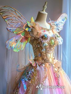 a dress made out of different types of sequins and beads with wings on it