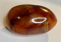 a large brown stone sitting on top of a white table