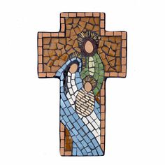 a cross made out of mosaic tiles with the image of jesus and mary on it