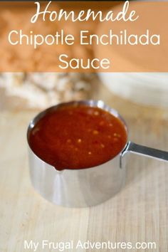 homemade chipotle enchilada sauce in a measuring cup on a wooden table