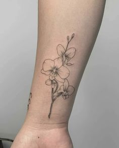 a small flower tattoo on the ankle