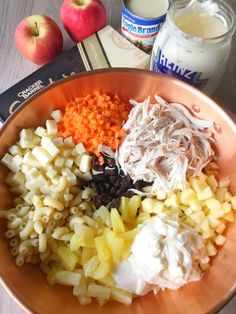 an orange bowl filled with different types of food next to some milk and other ingredients