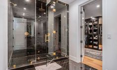 a walk in shower sitting inside of a bathroom next to a doorway with glass doors