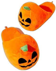 two orange slippers with pumpkin faces on the front and back, both have green eyes