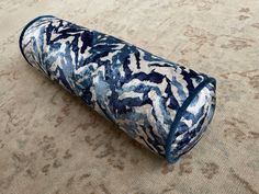 a blue and white vase sitting on top of a carpeted floor next to a rug