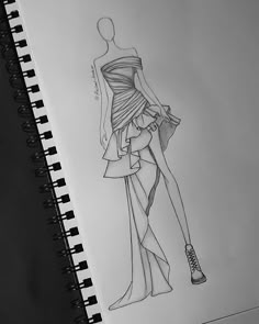 a drawing of a woman's dress and high heeled shoes on a notepad