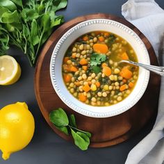 a bowl of soup with carrots, chickpeas and spinach on the side