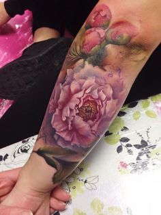 a person with a flower tattoo on their arm