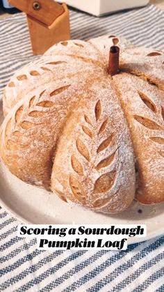 a white plate topped with bread on top of a blue and white striped table cloth