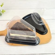 two desserts in plastic containers on a wooden tray