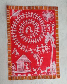 a red and orange cloth with white designs on it