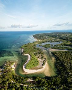 an aerial view of the beach and lagoons in the middle of the ocean with trees on both sides