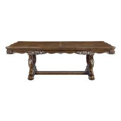 an old wooden table with carvings on the legs and wood grained top, isolated against a white background