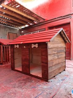 a dog house made out of wood and red paint