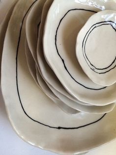 a stack of white plates with black lines on them