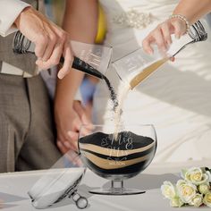 the bride and groom are pouring their wedding cake