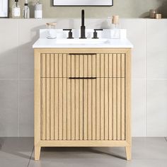 a bathroom vanity with two sinks and a mirror on the wall above it in a neutral color scheme