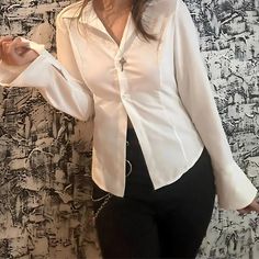 Embrace your unique style with our Gothic Slim Blouse, meticulously designed for those who appreciate a touch of darkness in their wardrobe. This versatile piece effortlessly blends elegance with history, featuring intricate lace detailing and a pirate-inspired ruffle front. Crafted from high-quality linen, it exudes both comfort and sophistication. Whether you're attending a casual gathering or a formal event, this blouse is perfect for making a statement. Dive into the depths of gothic aesthet Gothic Fitted Tops For Workwear, White Cotton Punk Shirt, History Dark Academia, White Pirate Blouse, Pirate Sleeve, White Victorian Shirt, Fitted Gothic Long Sleeve Shirt, White Victorian Blouses With Cleavage, Fitted Long Sleeve Gothic Shirt