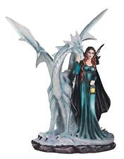 a statue of a woman standing next to a dragon on a white background with water