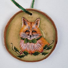 a ceramic ornament with an image of a fox on it