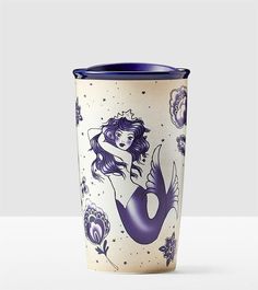 a blue and white cup with a mermaid on it