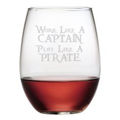 a wine glass with the words work like a captain play like a pirate on it