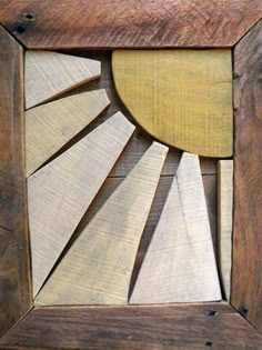 a wooden frame that has some wood cut out in the shape of a sunburst