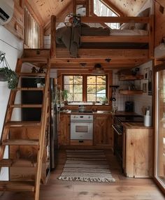 a small cabin with stairs leading up to the loft