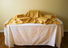 a white table topped with a yellow cloth