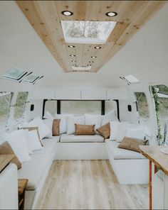 the inside of a camper with couches and tables