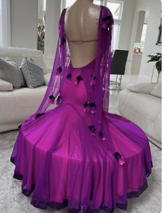 a mannequin wearing a purple dress with flowers on it's skirt and veil