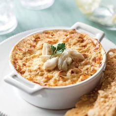 a white plate topped with food next to crackers