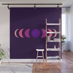 a purple and pink wall mural in a living room with a ladder to the right