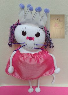 a white stuffed animal wearing a pink dress and a crown on top of it's head