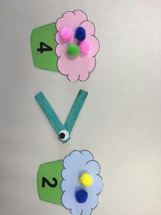 the paper flowers are cut out and placed on top of each other to make numbers