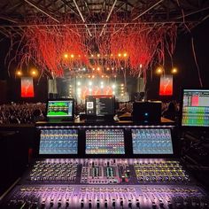 the control room at a concert with lights and sound equipment in front of an audience