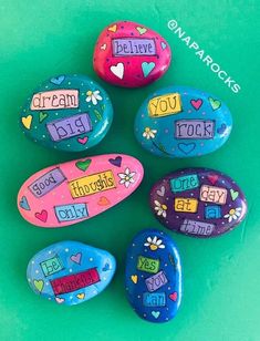 painted rocks with words and hearts on them