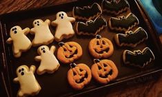 decorated cookies in the shape of ghost and pumpkins